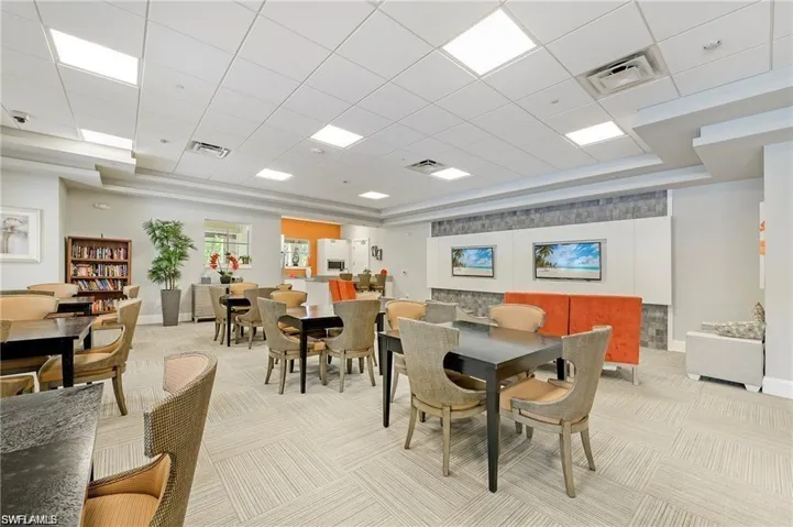 Dining room featuring light carpet and a tray ceiling