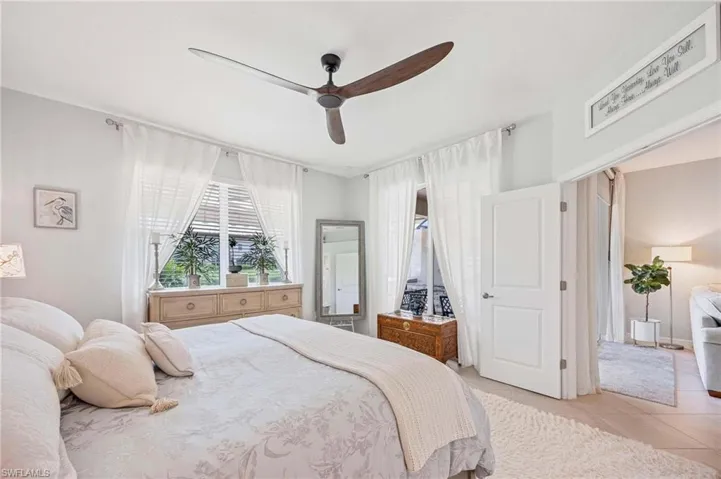 Bedroom with a ceiling fan and light tile patterned flooring
