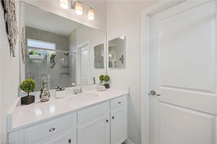 Bathroom featuring vanity and a shower stall
