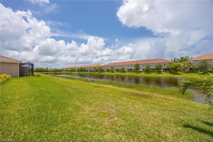 View of grassy yard featuring a water view and a residential view