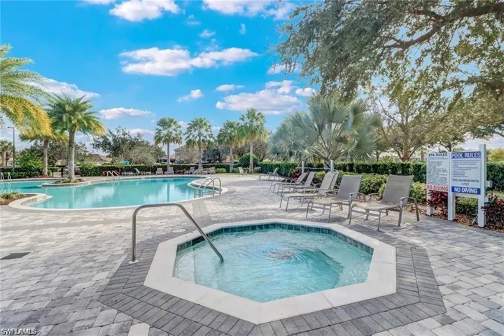 Community pool with a hot tub and a patio