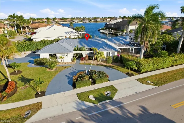 Aerial perspective of suburban area featuring a large body of water