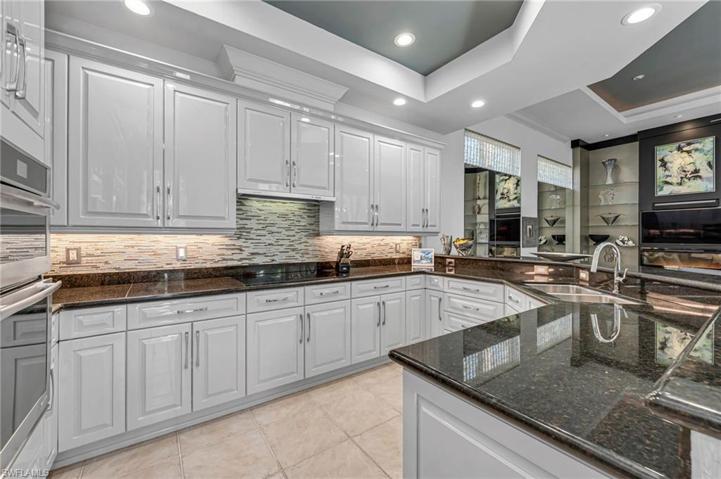 Kitchen has been updated with sophisticated touches to blend the designer's influence to the rest of the residence.