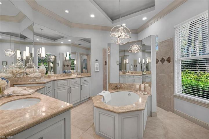 Primary bath has dual sinks, custom-painted cabinetry and LED lighting.  Your Spa bath awaits you!