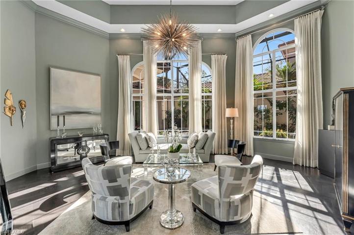 The formal living room has 16-foot ceilings and sets the tone for the rest of this residence.