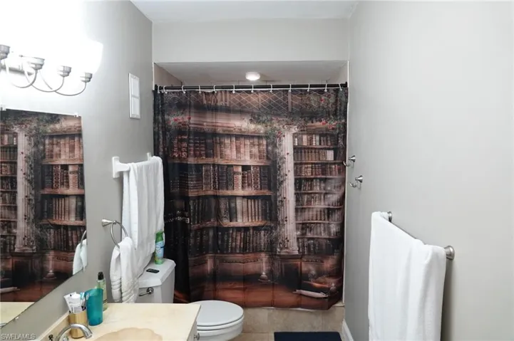 Bathroom featuring tile flooring, vanity, and toilet