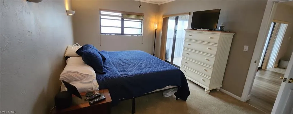 Carpeted bedroom featuring ornamental molding