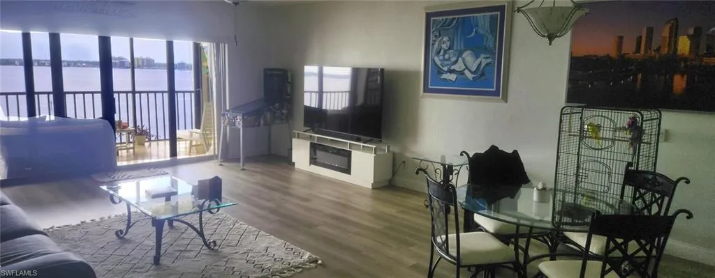 Living room featuring hardwood / wood-style floors and a water view