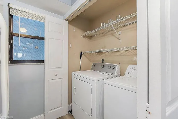 Clothes washing area featuring separate washer and dryer