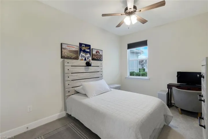 Bedroom featuring ceiling fan and carpet floors