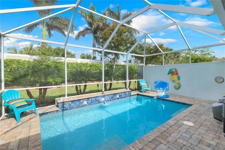 View of swimming pool featuring a lanai, a patio, and pool water feature