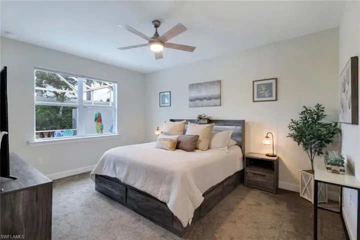 Carpeted bedroom with ceiling fan