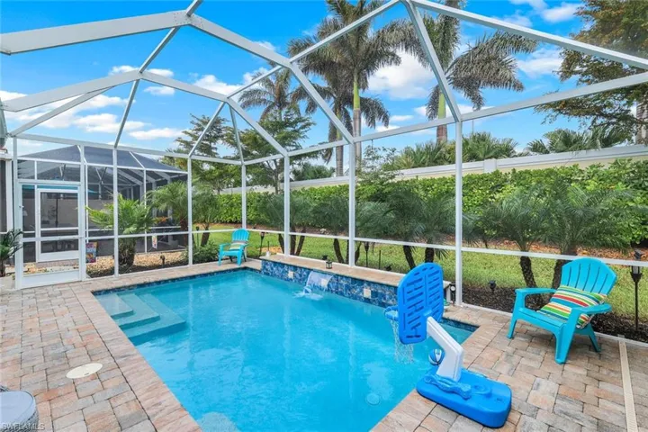View of swimming pool featuring a patio area, a lanai, and pool water feature