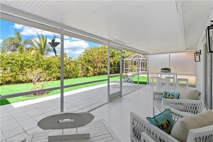 Sunroom with a patio area