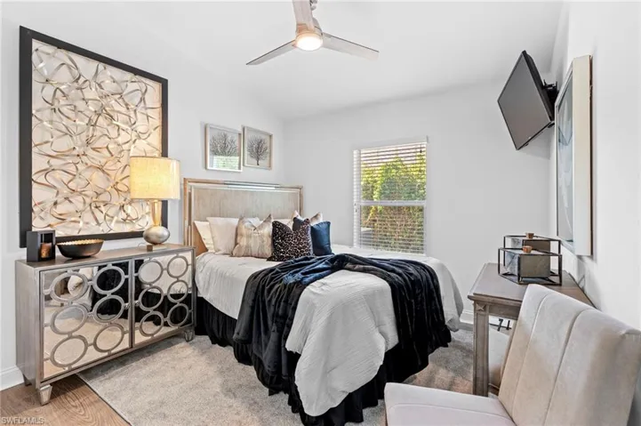 Bedroom with wood finished floors and ceiling fan