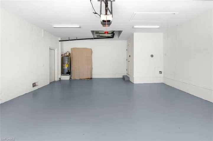 Garage with water heater and a garage door opener