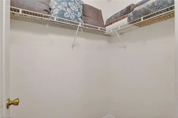 One of two walk in closets for primary bedroom.