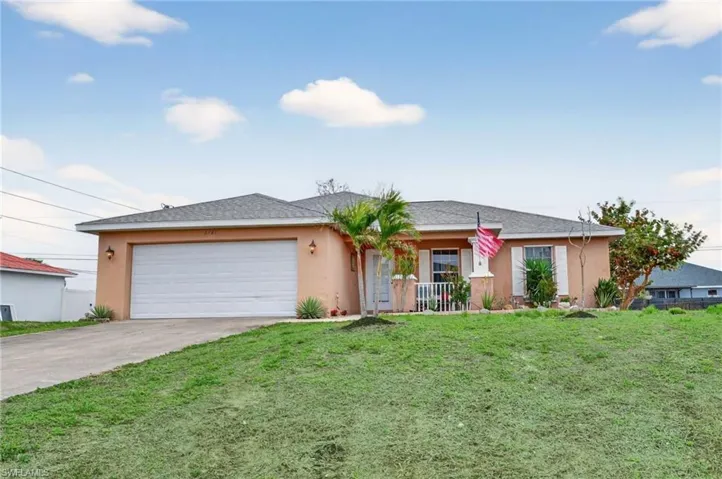 Ranch-style house featuring covered front porch, stucco siding, a front lawn, a garage, driveway, and roof with shingles