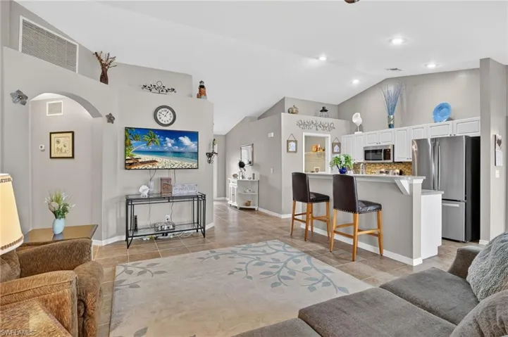 Living area featuring vaulted ceiling and convenient layout