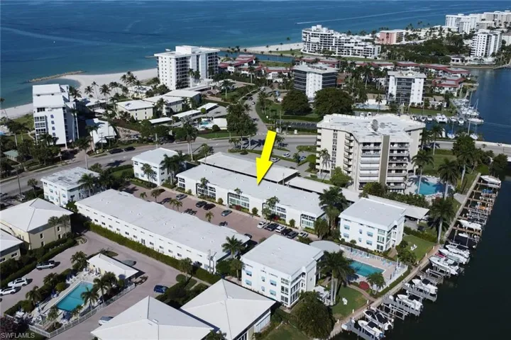 Aerial view of property and surrounding area with a large body of water and nearby urban area