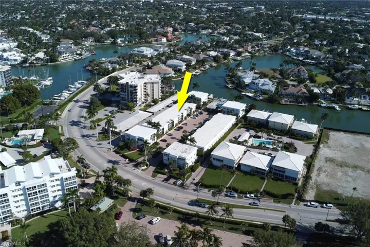 Aerial view of property's location with a large body of water