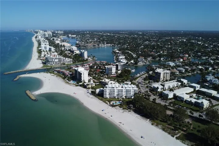View of property location featuring unending shoreline and nearby urban area