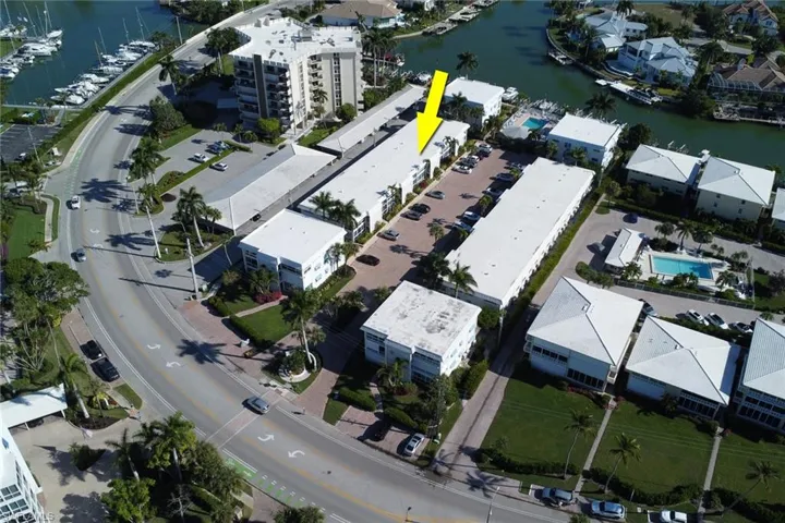 Aerial view of property's location with a large body of water
