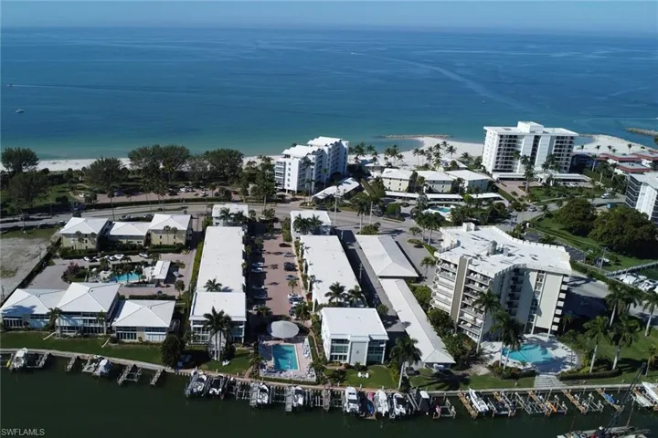 Aerial view of property and surrounding area featuring a nearby body of water