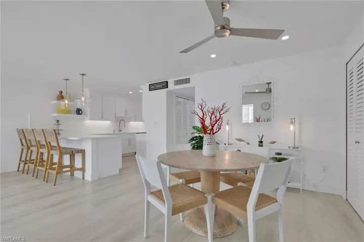Dining space with recessed lighting, light wood finished floors, and ceiling fan