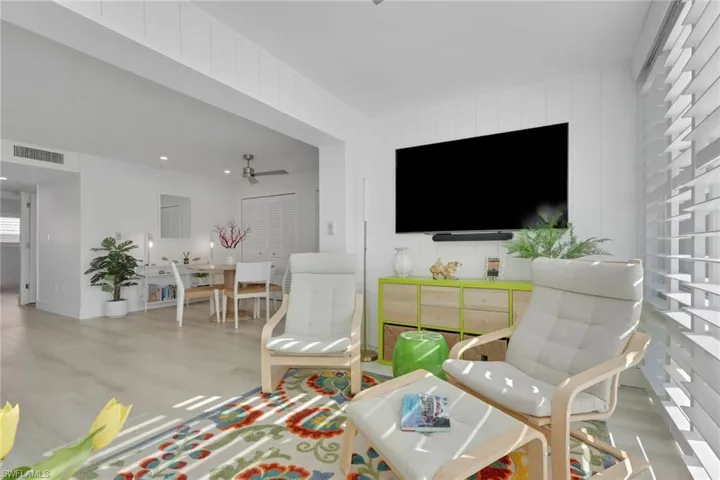 Recreation room featuring wood finished floors, a ceiling fan, and recessed lighting