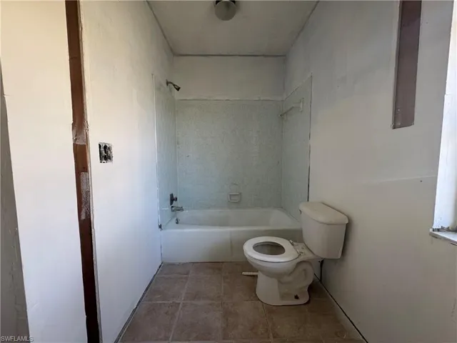 Bathroom featuring shower / tub combination and light tile patterned floors
