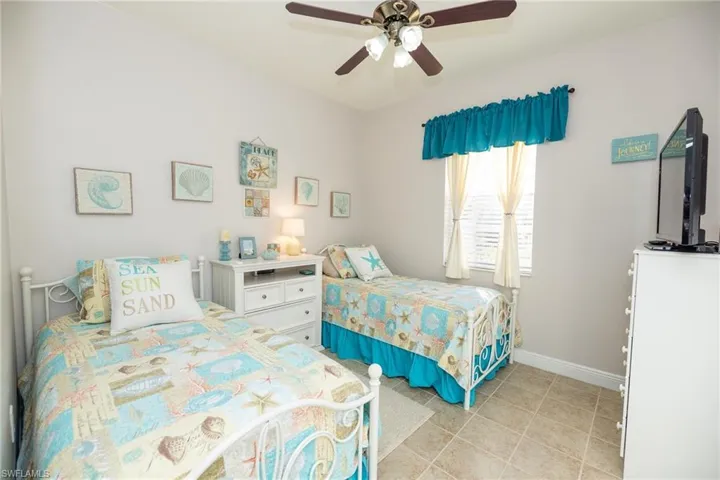 Bedroom featuring ceiling fan and light tile patterned flooring