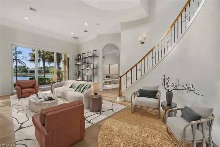 Virtually-staged foyer and living room.
