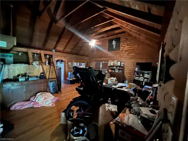 Miscellaneous room featuring hardwood / wood-style flooring, vaulted ceiling with beams, wood walls, and wood ceiling