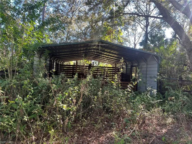 View of parking featuring a carport