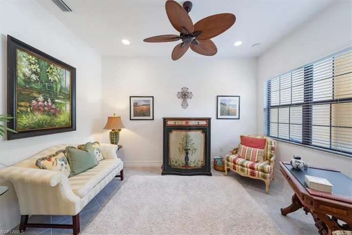 Living room featuring ceiling fan and light carpet