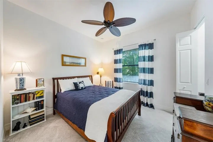 Bedroom featuring light tile patterned flooring and ceiling fan