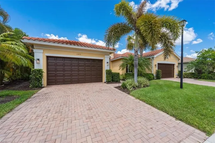 Mediterranean / spanish home featuring a garage and a front yard