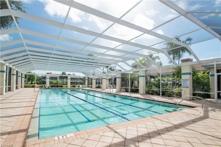 View of swimming pool featuring a patio and a lanai