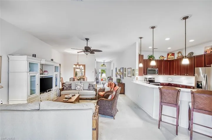 Living area featuring ceiling fan and a chandelier