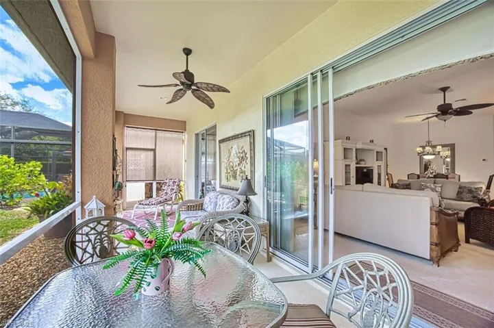 Sunroom with a ceiling fan and outdoor dining area