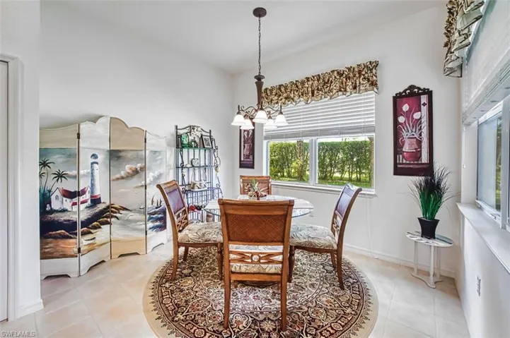 Dining room featuring suspended lighting and light tile patterned floors