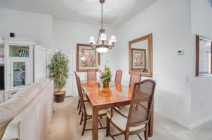 Dining area with a chandelier and baseboards