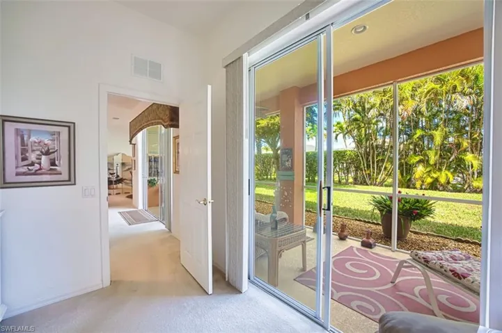 Doorway with carpet floors and baseboards