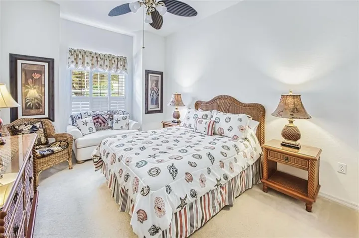 Carpeted bedroom featuring a ceiling fan