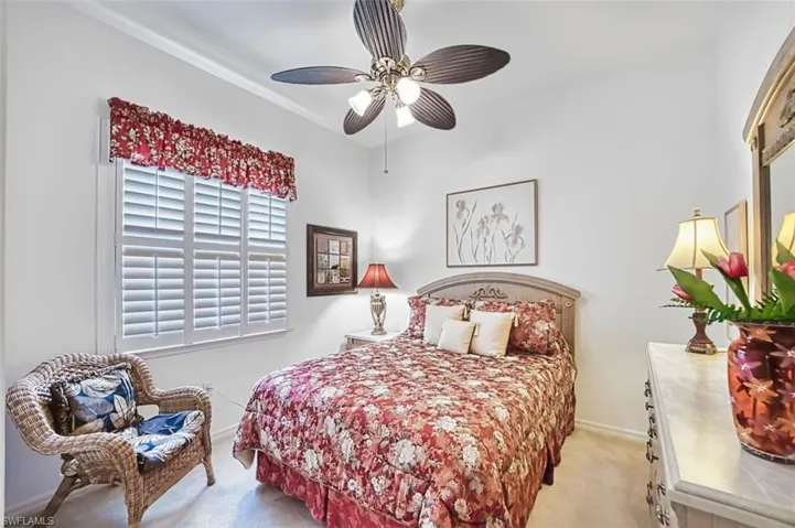 Bedroom featuring light carpet and a ceiling fan