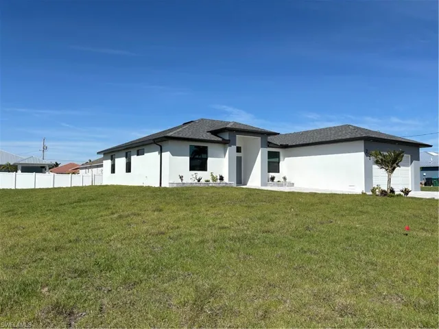 Prairie-style home, a front lawn, and stucco siding