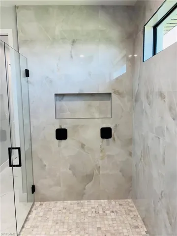 Full bathroom featuring a shower stall