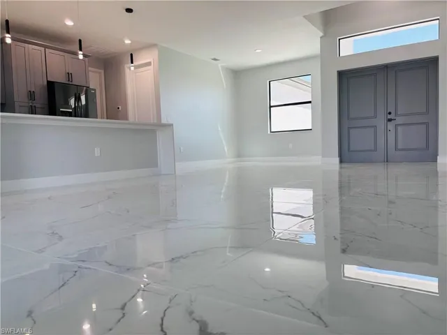 Foyer entrance featuring porcelain finish floor and recessed lighting