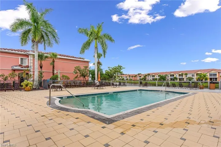 Community pool featuring a water view, and large patio